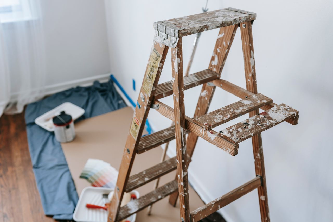 Crafting Captivating Headlines: Your awesome post title goes here A messy stepladder and painting tools set up for a home interior renovation project.